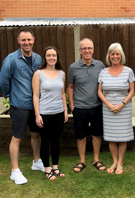 Family standing in garden, son, daughter in law, mum and dad