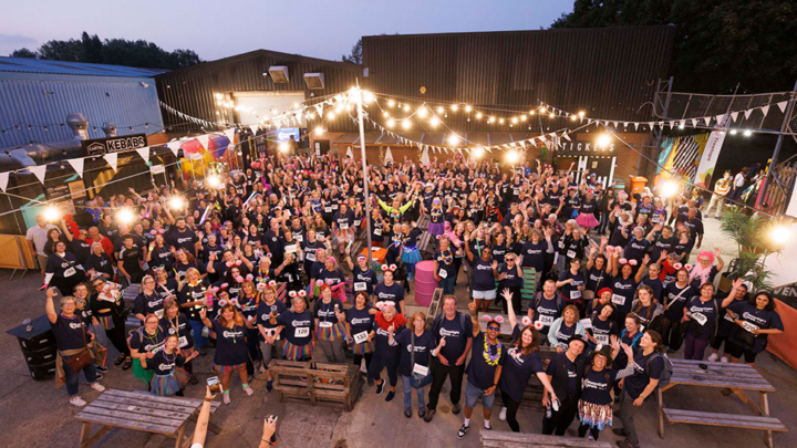 Large group of Moonlight Walkers waving up. Photo credit Richard Richards Photography